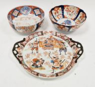 Two Japanese Imari porcelain bowls, 19th century, the first painted with lozenge and cloud shaped