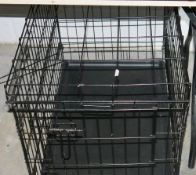 Black painted metal wire pet crate and various stair gates