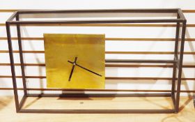 Minimalist clock, having a gilt metal square clock face suspended within a rectangular metal box