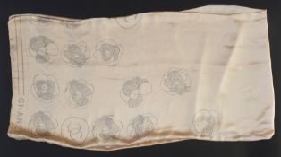 Chanel silk scarf in pale pink/apricot, printed with camelia design and the logo Chanel in black