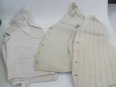 Quantity of vintage gent's white poplin and other waistcoats, collarless shirts by Charles Baker