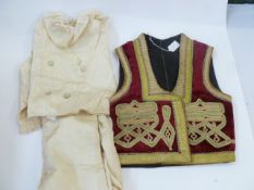A Turkish embroidered waist coat and a 1950's satin pageboy suit for a 5/6 year old (2)