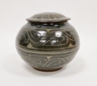 A St. Ives studio pottery lidded pot, incised scroll work decoration on dark olive ground, impressed