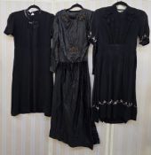 Various black period dresses, some adapted for theatrical use, to include a 1920's satin dress