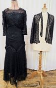 A black lace 1920's style evening dress, embellished with sequins and a ruched frill around the