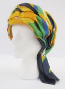 Christian Dior licenced chapeaux, a silk scarf formed as a turban-style hat with silver-coloured met