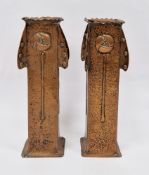 In the manner of J&F Pool Hayle Cornwall, a pair of Arts and Crafts copper vases in the secessionist