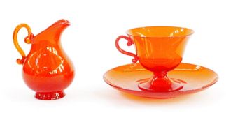 Venetian orange glass cup and saucer by Pauly signed and a similar cream jug (3)