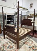 Mahogany four-poster small double bed frame, the foliate carved uprights with domed finials,