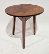 19th century elm and oak cricket table, the oval top on three tapering triangular chamfered legs,