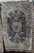 Persian silk blue ground rug with central floral medallion on floral field, spandrels and multiple