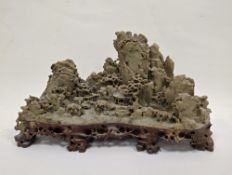 Chinese carved soapstone model of a mountainous village with pine trees and a pierced red