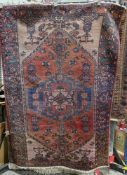 Eastern red ground rug with central geometric medallion on geometric shape field, geometric