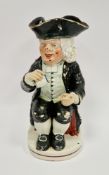 Staffordshire pearlware Drunken Parson toby jug, early 19th century, modelled seated holding a