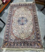 Large Persian style cream ground rug with central floral medallion on floral woven field, floral