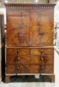 Early 19th century mahogany and mahogany veneered linen press, the moulded carved cornice over two