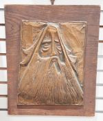 Mid-century copper wall plaque having embossed decoration representing a bearded man with long hair,