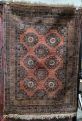 Eastern red ground rug with two rows of three hooked octagonal medallions and one row of two