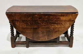 17th or 18th century oak gate-leg table, the oval top on bobbin and block support, 69cm high x 148cm
