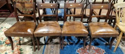 Set of four Regency mahogany dining chairs with channelled top rail, stuffover seat, on sabre