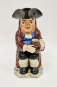 Staffordshire pearlware toby jug, early 19th century, modelled seated holding a jug of ale,