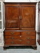 George III mahogany linen press, the moulded dentil cornice over two panel doors opening to four oak