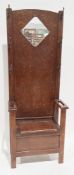 Art Deco oak hallstand, the back with mirror and six coat hooks, the lift lid to seat flanked by two