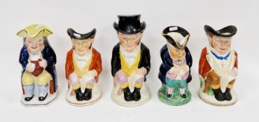 Five Staffordshire pottery toby jugs, comprising: a 19th century toby seated with a yellow hat,