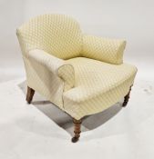 19th century low armchair, upholstered in a lemon and cream patterned fabric, on walnut turned