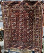 Eastern red ground rug with three rows of eight elephant foot guls, multiple geometric borders