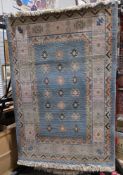 Modern blue ground rug with three rows of seven alternating geometric shapes, multiple geometric