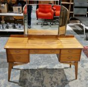 Mid century Alfred Cox teak dressing table, comprising a triptych dressing mirror over an