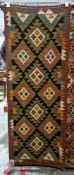 Maimana green ground kilim runner with two rows of three and one row of four lozenge medallions,