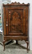 18th century walnut corner cabinet on stand having serpentine pediment, shaped shelves enclosed by