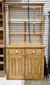 19th century pine dresser, the upper section with open back and two shelves graduating in depth, the