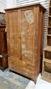 Modern hardwood wardrobe by Heals of London, the two panel doors opening to a hanging space, over