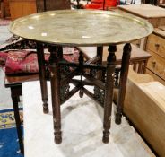 Benares style brass top table, the circular tray top with engraved decoration including enamels,