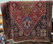 Eastern red ground rug with three central lozenge medallion on geometric field, geometric