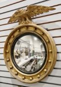 19th century gilt wood convex wall mirror, the moulded circular frame with applied balls and
