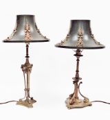 Two similar brass table lamps in the neo-classical manner, one with triform bases and swag and