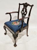 Mahogany elbow chair in the Chippendale manner, with pierced carved splat and woolwork embroidered