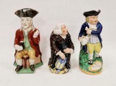 Three Staffordshire pottery toby jugs, comprising: a Squire Toby jug, a Nightwatchman toby jug on