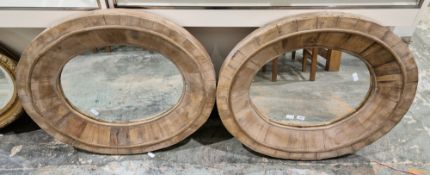 Pair of contemporary rustic wall mirrors, of oval form with thick segmented pine frames, 82cm x 70cm