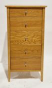 Modern oak chest of five short graduated drawers with metal knob handles, on square legs, 111cm high