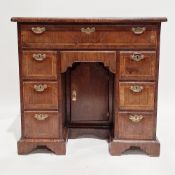 Mid-18th century mahogany kneehole desk, the top crossbanded with incuse corners, fitted single