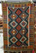 Maimana orange ground kilim with two rows of four lozenge medallions, single geometric border