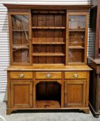 Late 19th/early 20th century oak dresser, the moulded cornice above two glazed doors enclosing