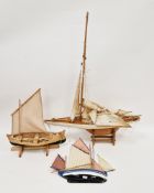 Wooden model yacht with white painted hull,  three sails  a/f), on stand, 86cm high x 66cm long