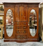 Edwardian inlaid mahogany breakfront compactum with inlaid dentil cavetto and ogee cornice, the