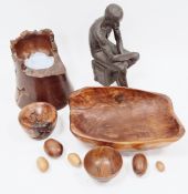 Bronze effect sculpture of a semi-naked seated man, 34cm high together with a collection of treen